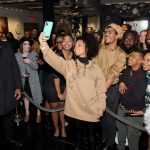 Alicia Keys takes a selfie in front of a group of fans