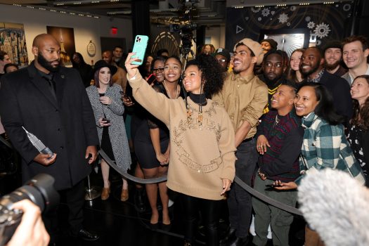Alicia Keys takes a selfie in front of a group of fans