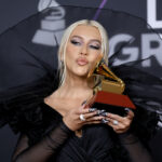 Christina Aguilera holds a grammy with a kisssy face